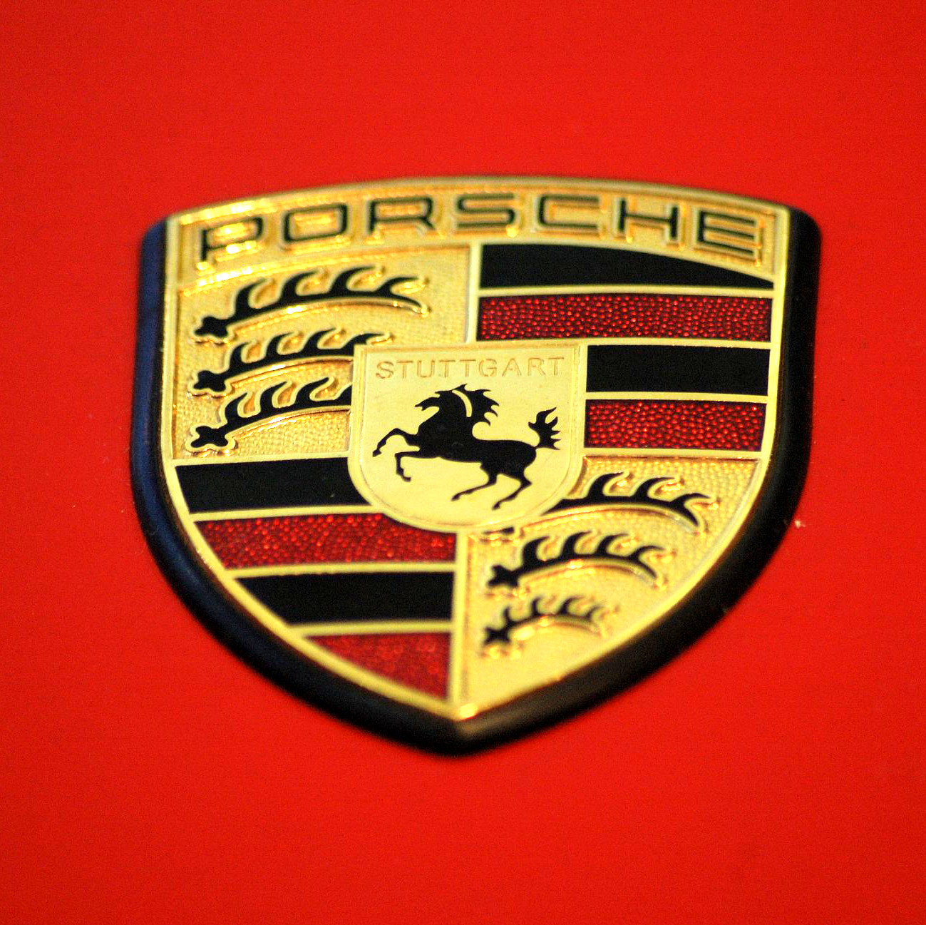Porsche Emblem on red background