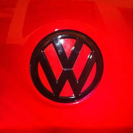 Black Volkswagen Emblem on red background