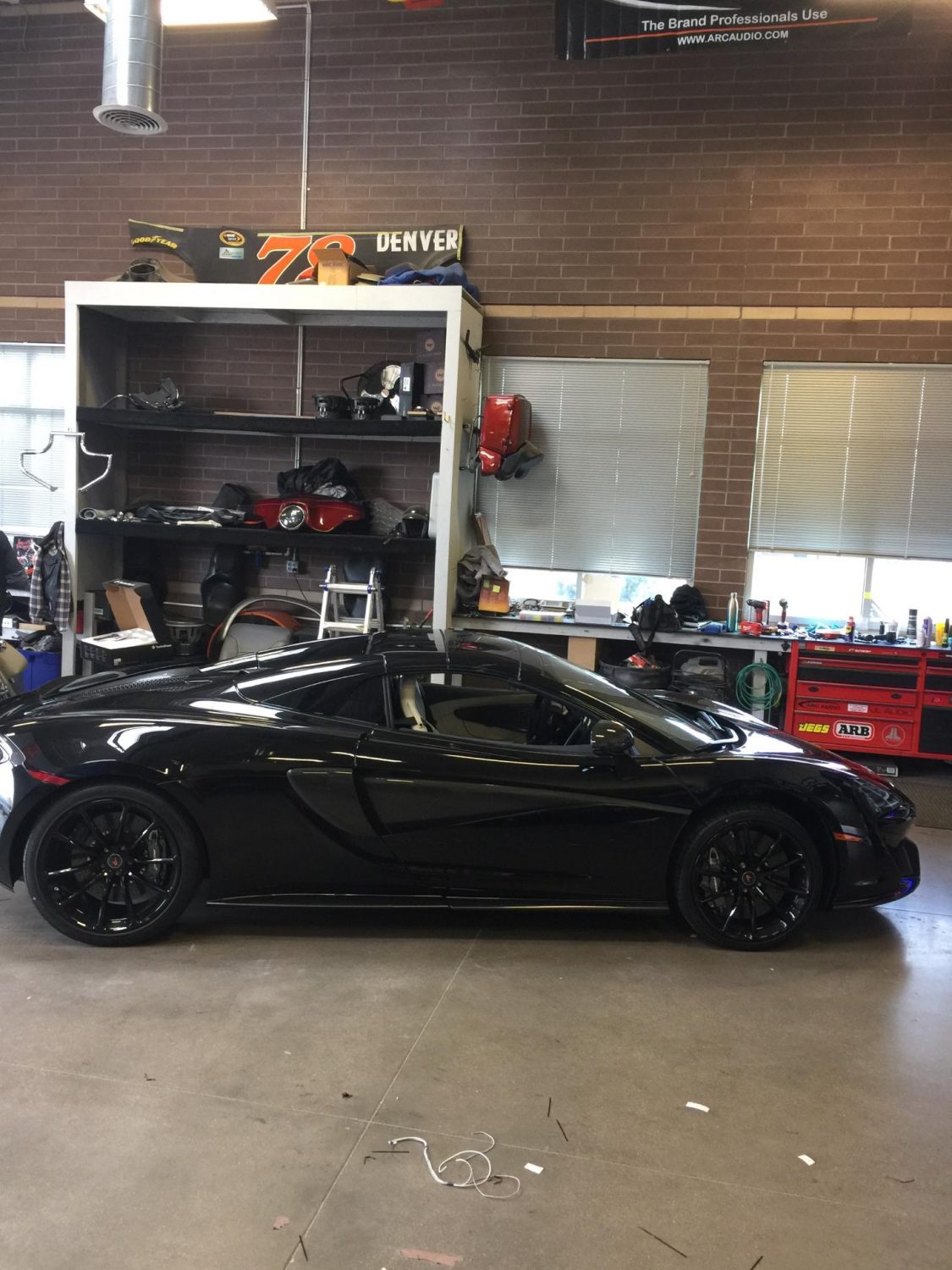 sideview of a 2018 Mclaren 570s spider in a shop