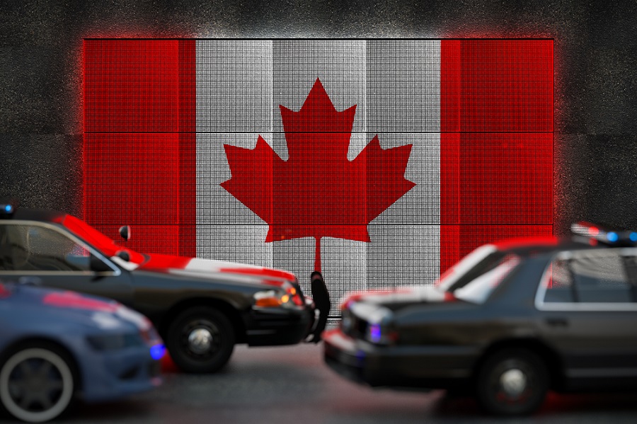Bright digital display Canadian flag in city as cars drive past